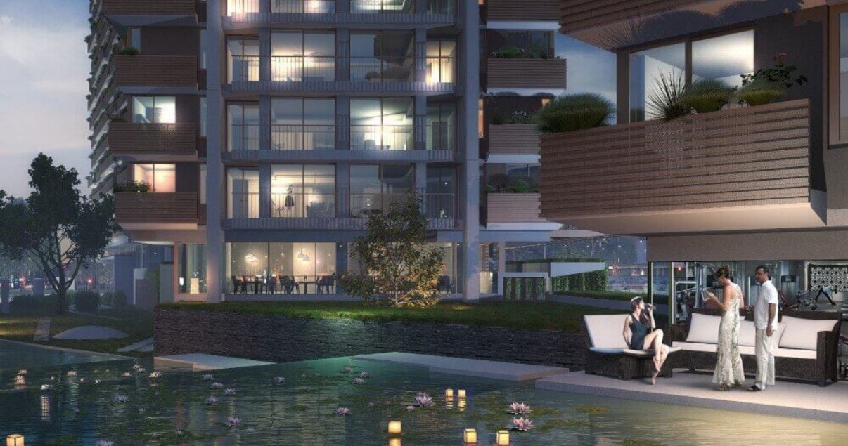 Areas común residencial de Distrito M vista del exterior de los edificios y una pileta y personas conversando afuera