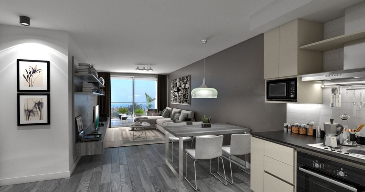 Interior moderno y claro del living-cocina de un apartamento en el edificio AVA La Caleta del estudio de arquitectos BMA