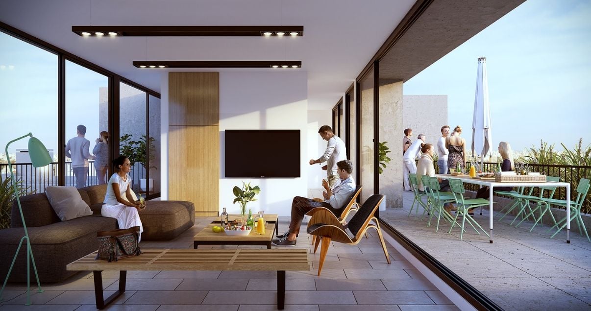 Interiror del salon de usos multiples con sillones y terraza en el edificio Dómini Rivera y Salterain del estudio de arquitectos Pablo Szames